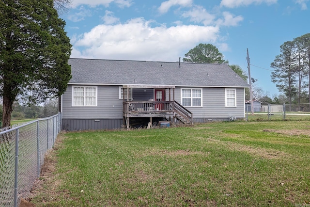 back of house featuring a deck and a lawn