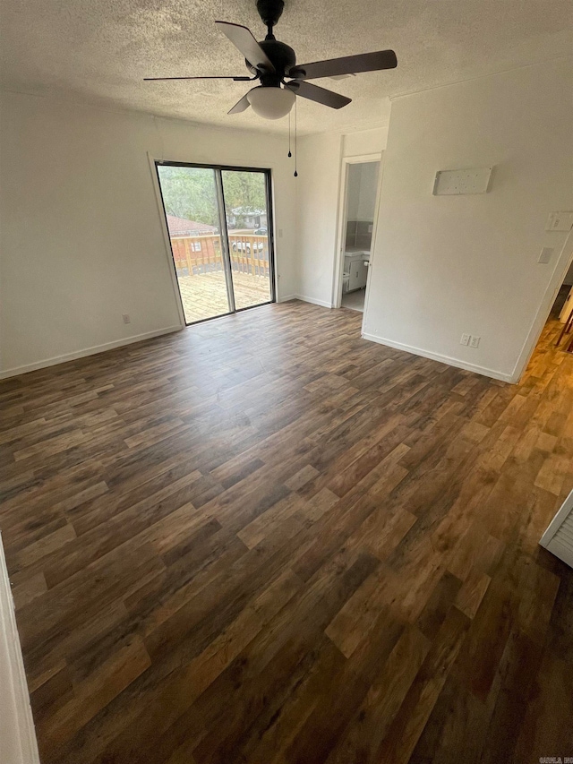 spare room with a textured ceiling, ceiling fan, and dark wood-type flooring