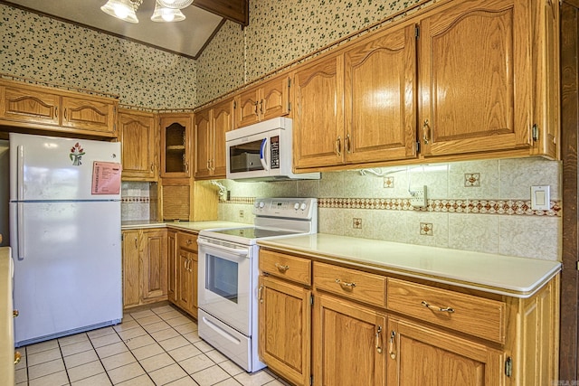 kitchen featuring decorative backsplash, light tile patterned floors, and white appliances