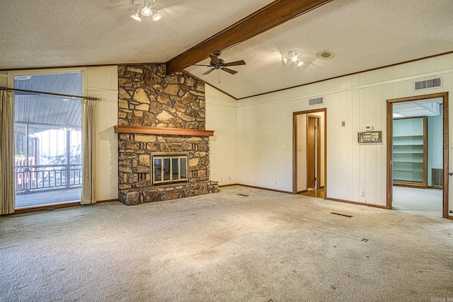 unfurnished living room featuring ceiling fan, a stone fireplace, vaulted ceiling with beams, carpet floors, and a textured ceiling