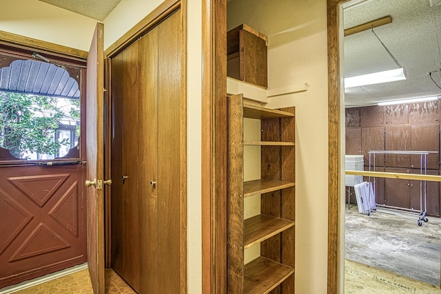 interior space featuring a textured ceiling and light hardwood / wood-style floors