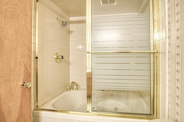 bathroom with shower / bath combination with glass door