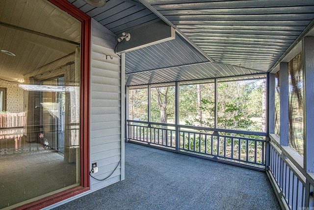 unfurnished sunroom featuring lofted ceiling