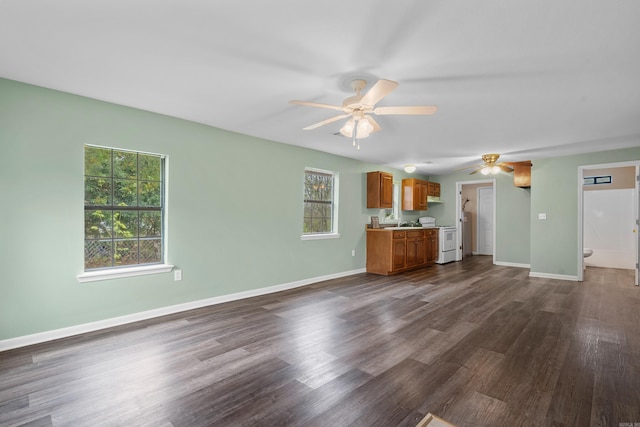 unfurnished living room with ceiling fan and dark hardwood / wood-style flooring