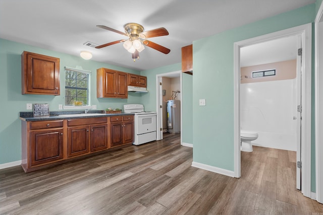 kitchen with hardwood / wood-style floors, electric water heater, ceiling fan, and electric stove