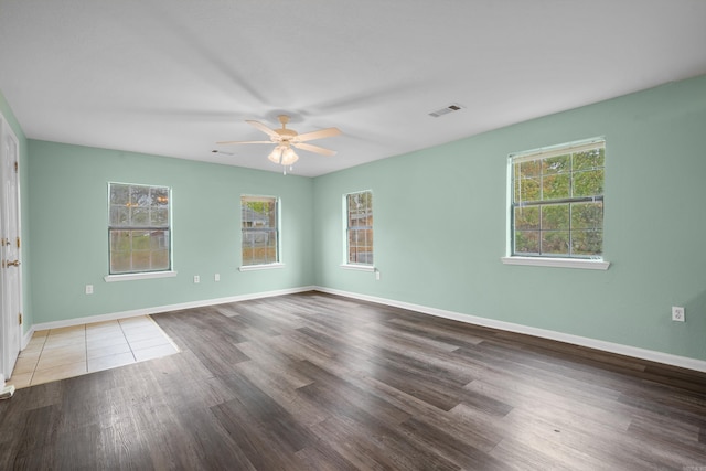 spare room with wood-type flooring and ceiling fan