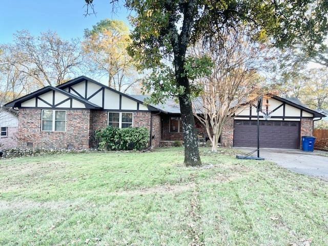 view of front of property with a front lawn and a garage