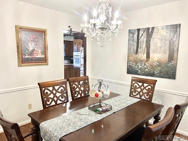 dining space featuring a chandelier and hardwood / wood-style flooring