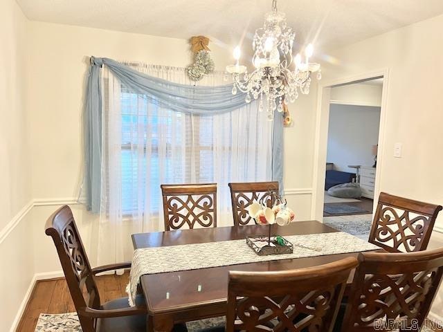 dining space featuring a chandelier and wood-type flooring