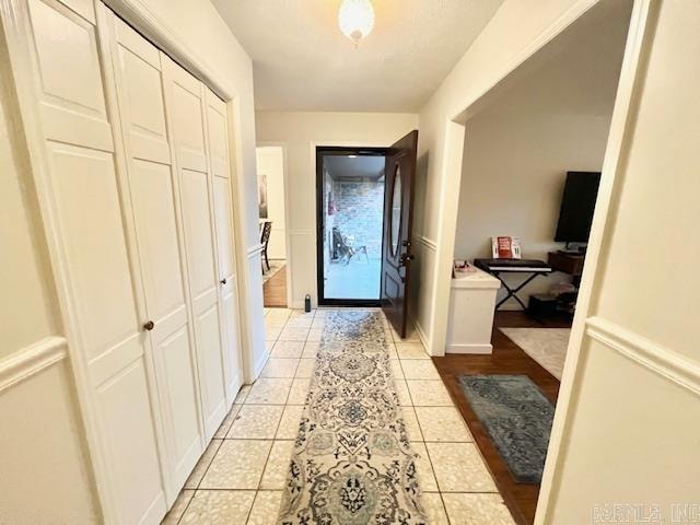 corridor featuring light tile patterned flooring