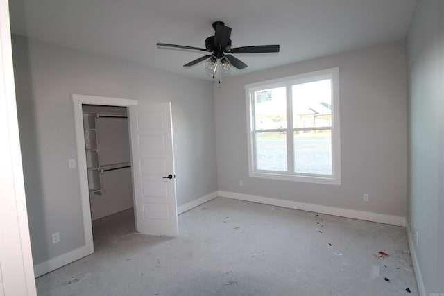 unfurnished bedroom featuring a spacious closet and a closet