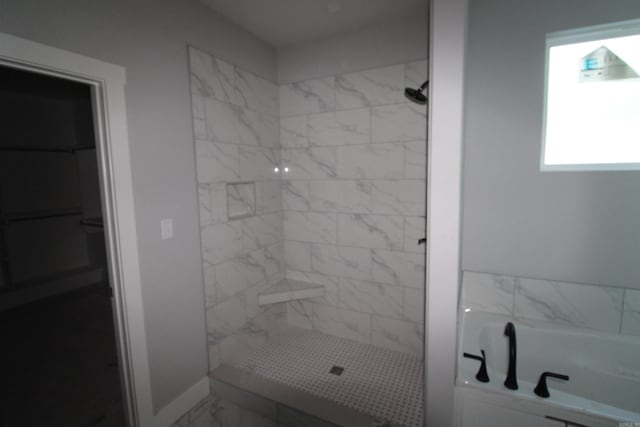 bathroom featuring separate shower and tub