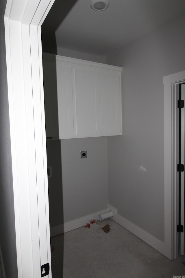 clothes washing area with cabinets and hookup for an electric dryer