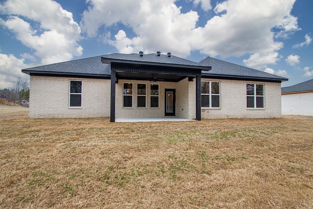 rear view of house with a yard and a patio area