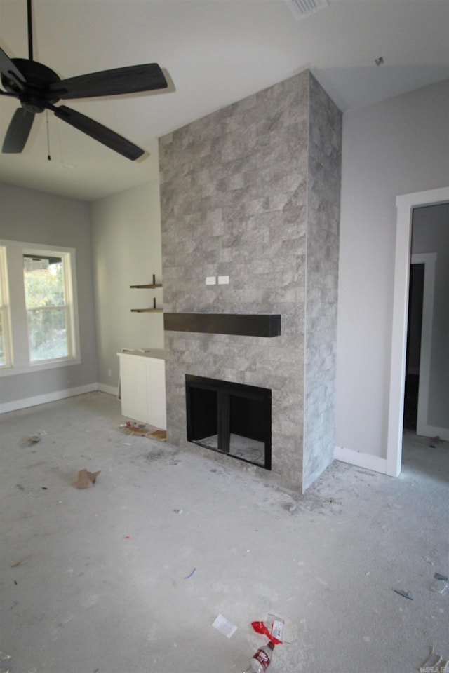 unfurnished living room featuring ceiling fan, radiator, and a fireplace