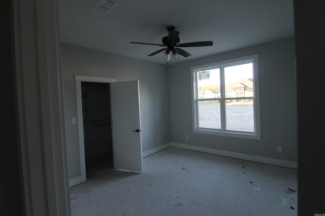 unfurnished bedroom featuring a walk in closet