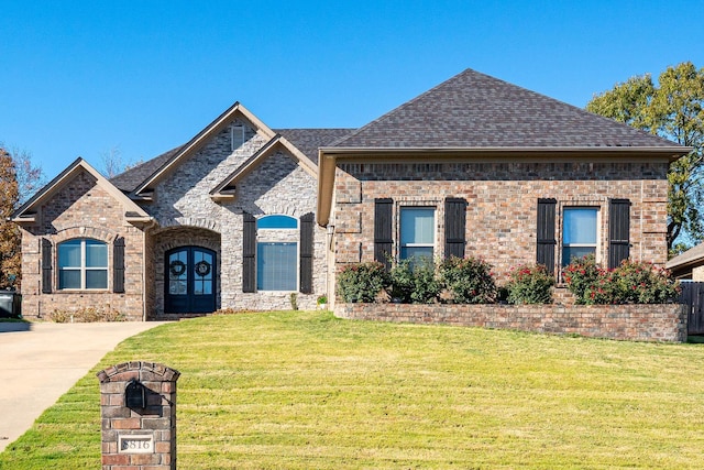 view of front of property featuring a front lawn and french doors