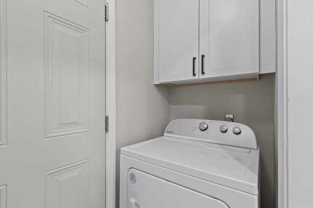 washroom featuring cabinets and washer / dryer