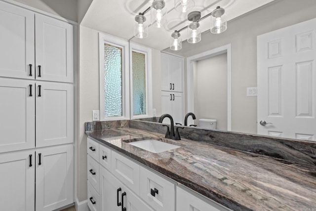 bathroom with vanity and toilet