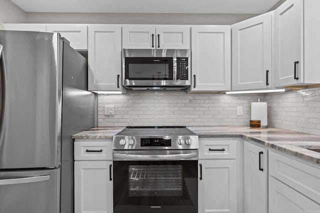 kitchen featuring backsplash, white cabinetry, and stainless steel appliances