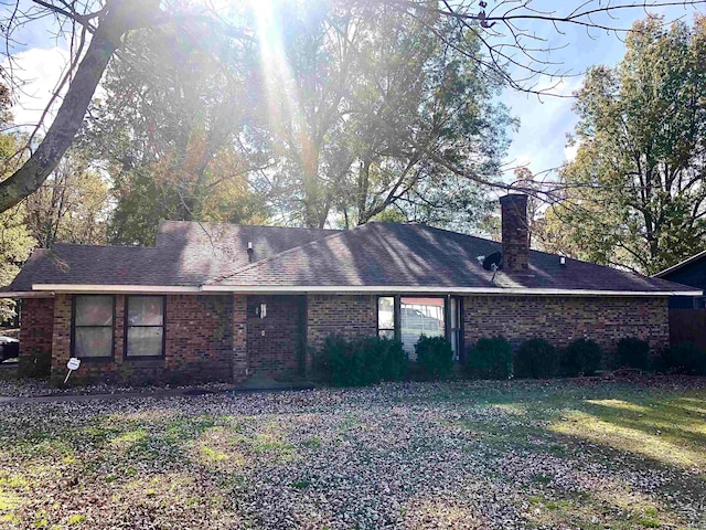 back of property featuring a yard