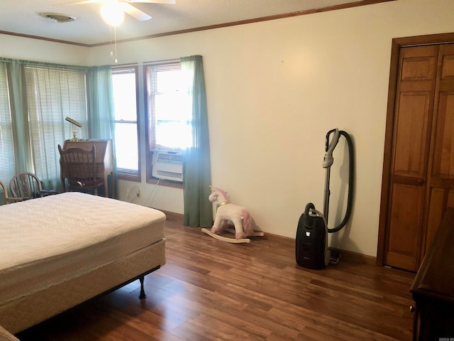 bedroom with ceiling fan, dark hardwood / wood-style flooring, and crown molding