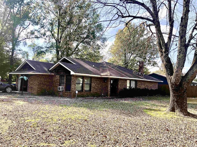 ranch-style house featuring cooling unit