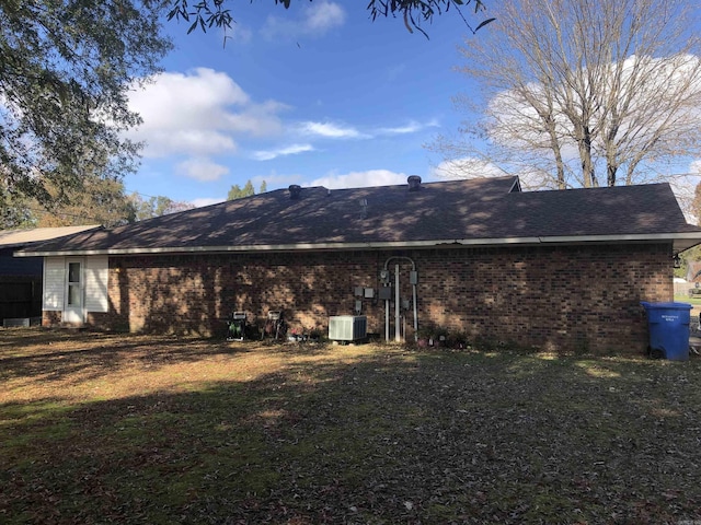 2509 Cherry St, Corning, AR 72422 - back of property featuring central air condition unit, brick siding, and a yard