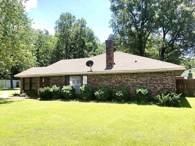 2509 Cherry St, Corning, AR 72422 - view of front of home featuring brick siding, a chimney, and a shingled roof
