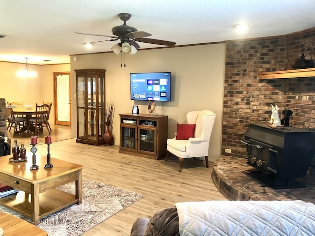2509 Cherry St, Corning, AR 72422 - living area featuring ceiling fan, wood finished floors, and a wood stove