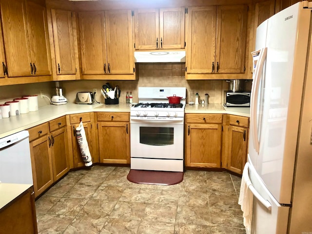 kitchen with decorative backsplash and white appliances