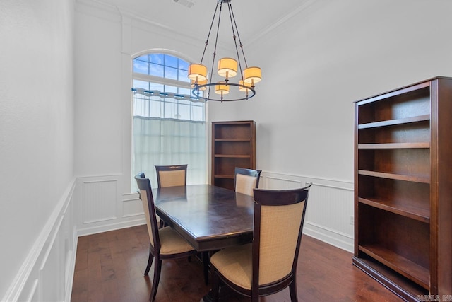 dining area featuring a chandelier, dark hardwood / wood-style flooring, and crown molding