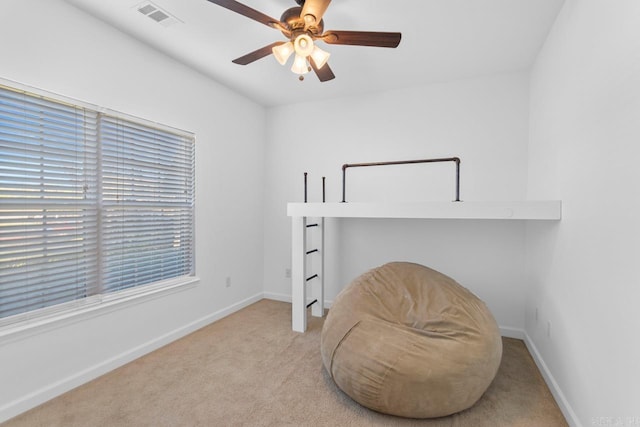 sitting room featuring ceiling fan and light carpet