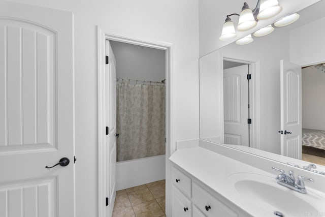 bathroom featuring tile patterned flooring, vanity, shower / bath combo with shower curtain, and an inviting chandelier