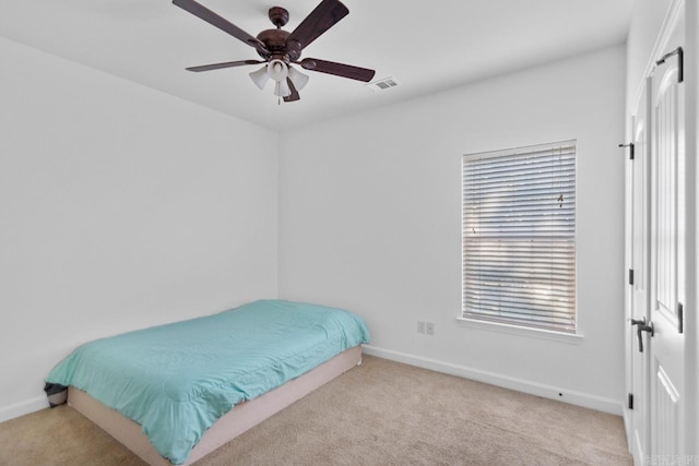 carpeted bedroom with ceiling fan