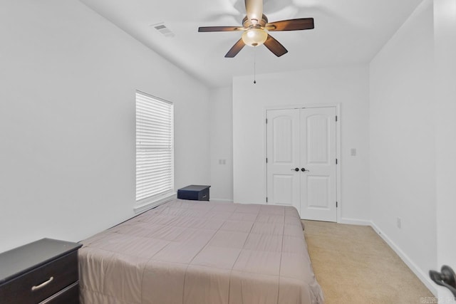 bedroom with light colored carpet and ceiling fan