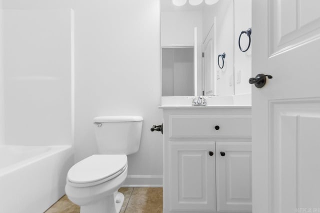 bathroom featuring tile patterned flooring, vanity, and toilet