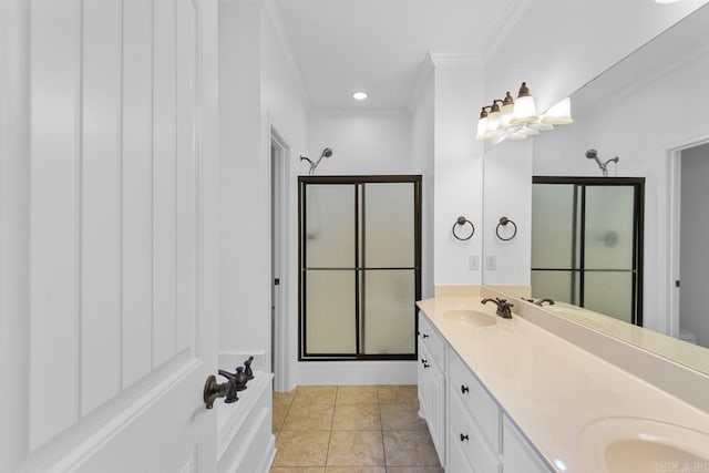 bathroom with tile patterned floors, a shower with shower door, ornamental molding, and vanity