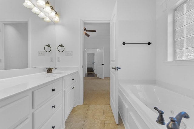 bathroom with a bathing tub, tile patterned flooring, ceiling fan, and vanity