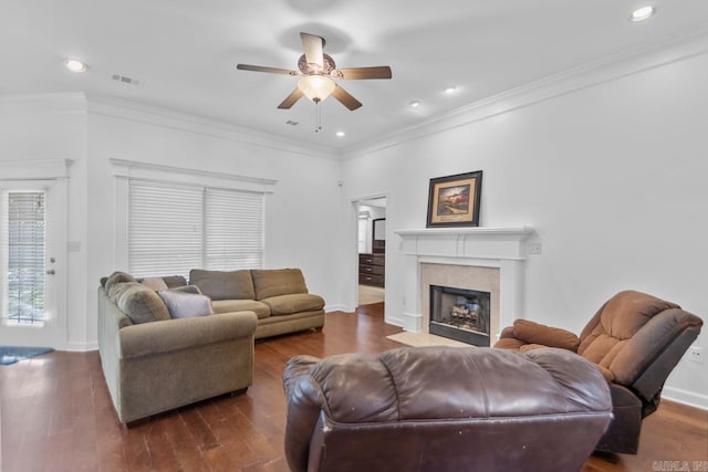 living room with dark hardwood / wood-style floors, ceiling fan, and crown molding