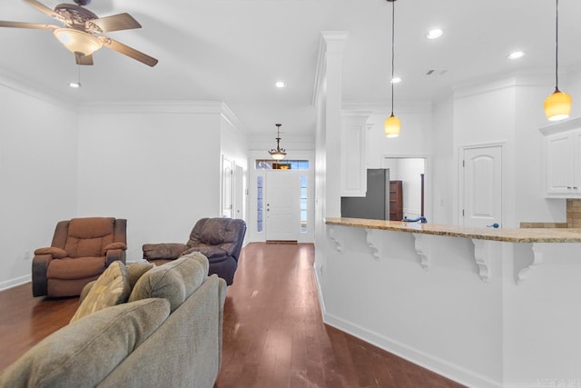 living room featuring crown molding, ceiling fan, and dark wood-type flooring