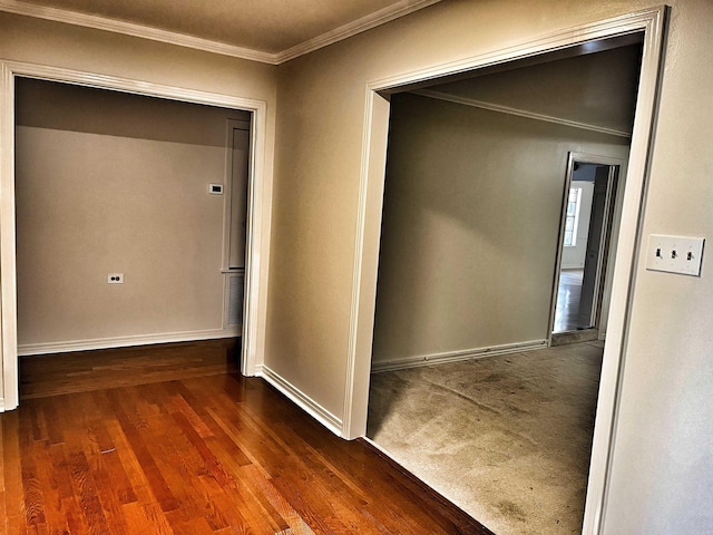 hallway with dark hardwood / wood-style flooring and ornamental molding