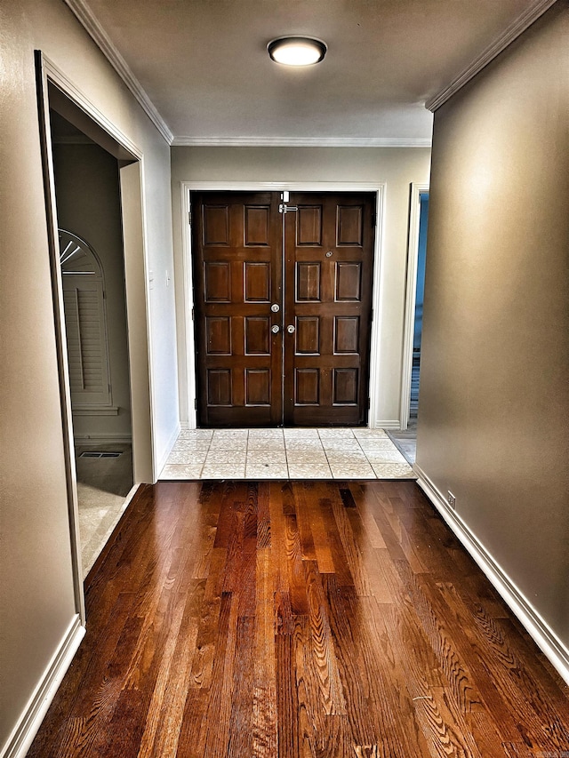 entryway with light hardwood / wood-style flooring and crown molding