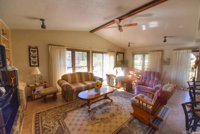 living room featuring vaulted ceiling with beams, ceiling fan, and a textured ceiling