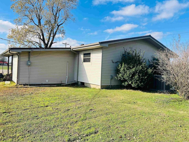 view of side of property with a lawn