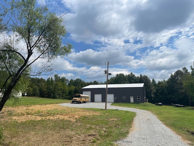 view of outdoor structure with a garage and a lawn