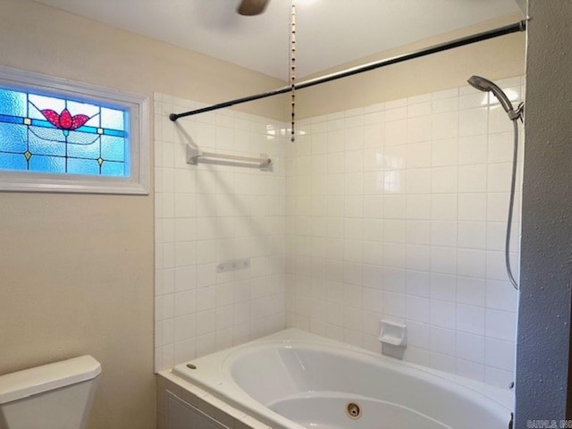 bathroom with tiled shower / bath and toilet