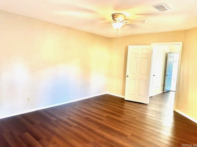 spare room featuring dark hardwood / wood-style flooring and ceiling fan