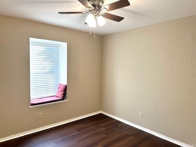 empty room featuring ceiling fan and dark hardwood / wood-style floors