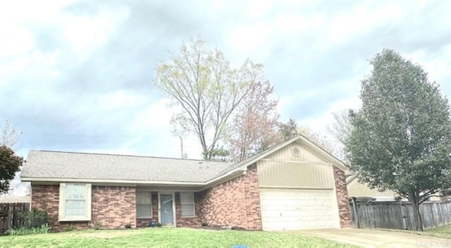 ranch-style home with a front yard and a garage